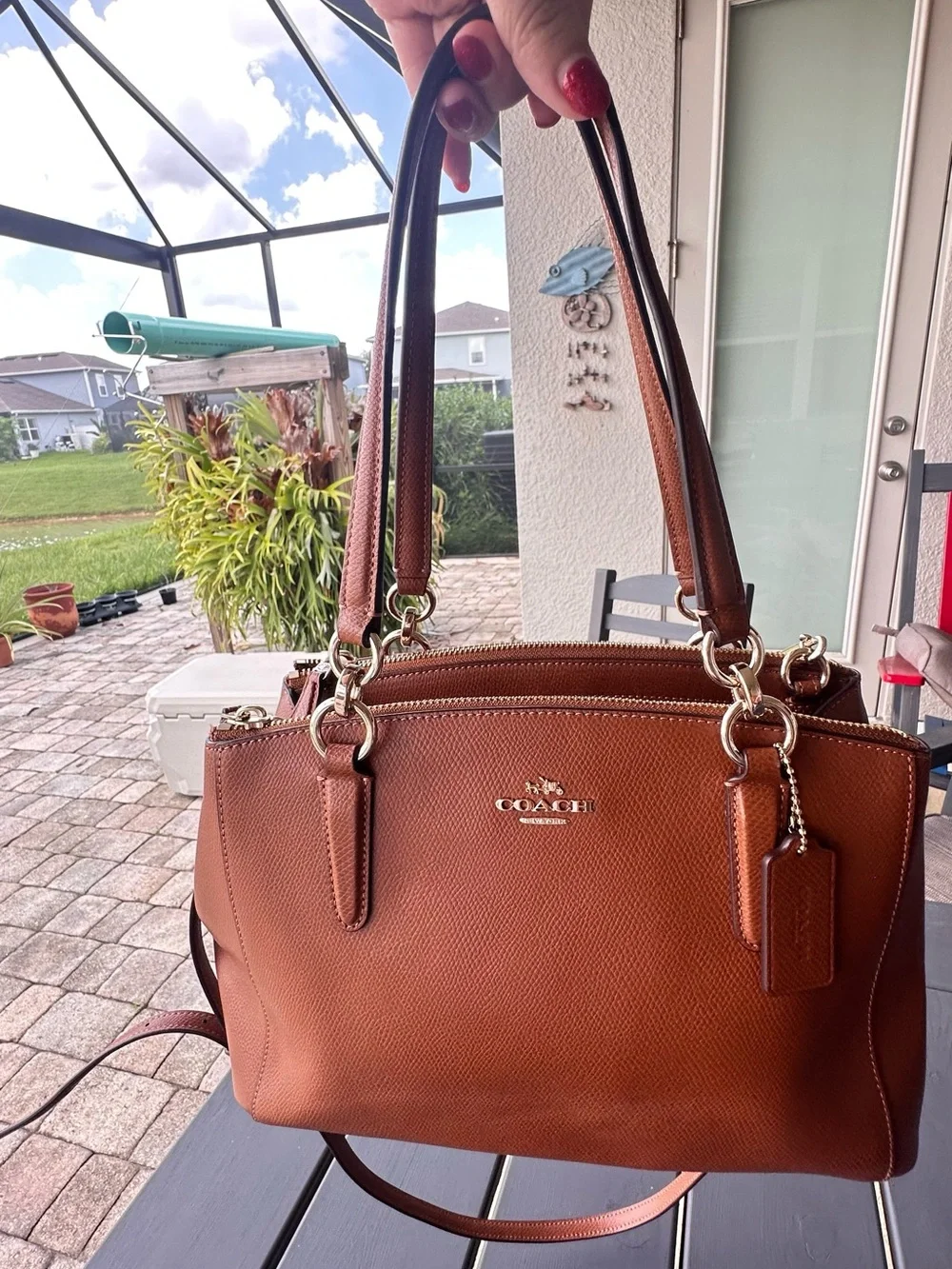 Coach Christie Carryall in a brown, textured leather with gold-tone hardware